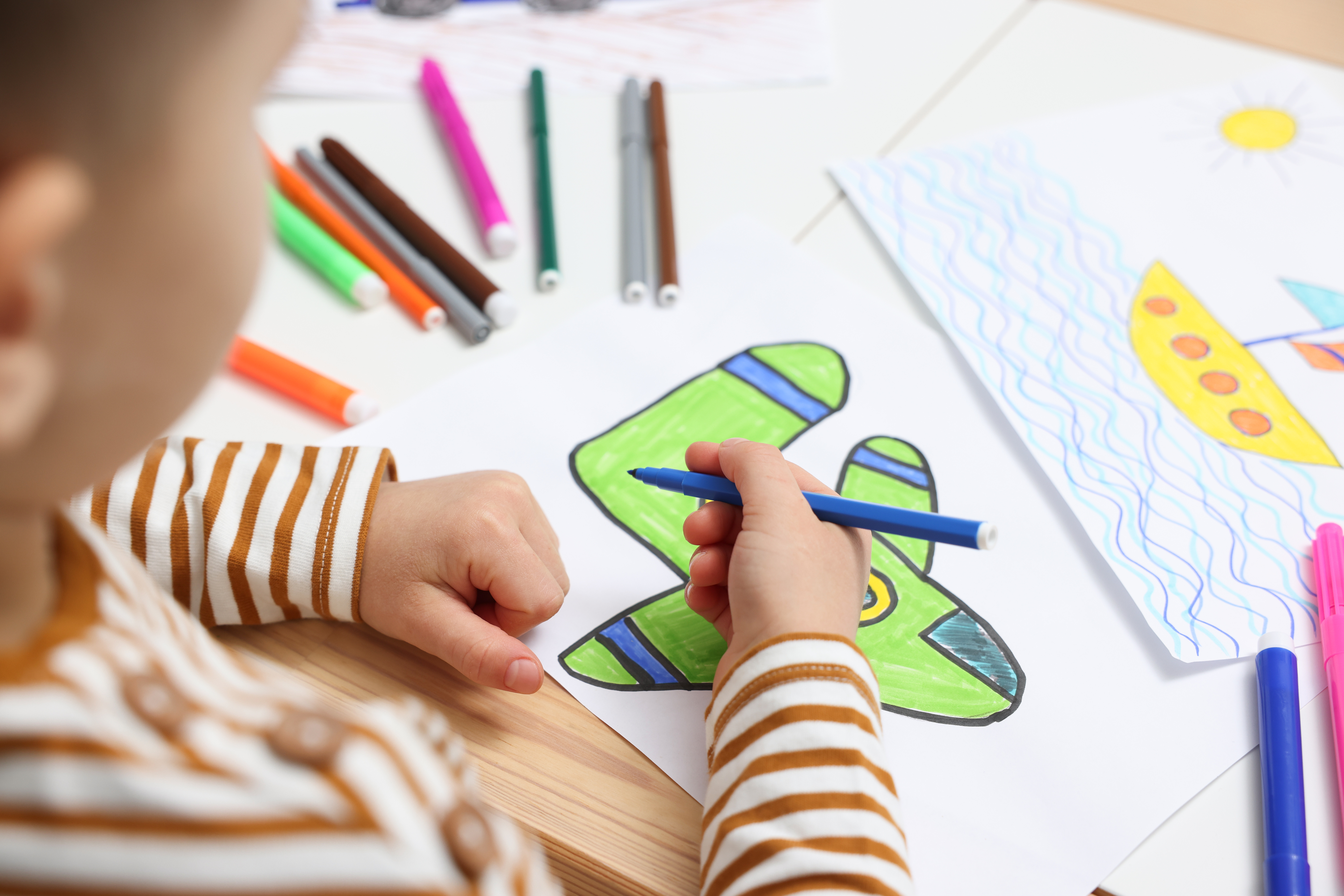 Child coloring at Preschool Learn Time